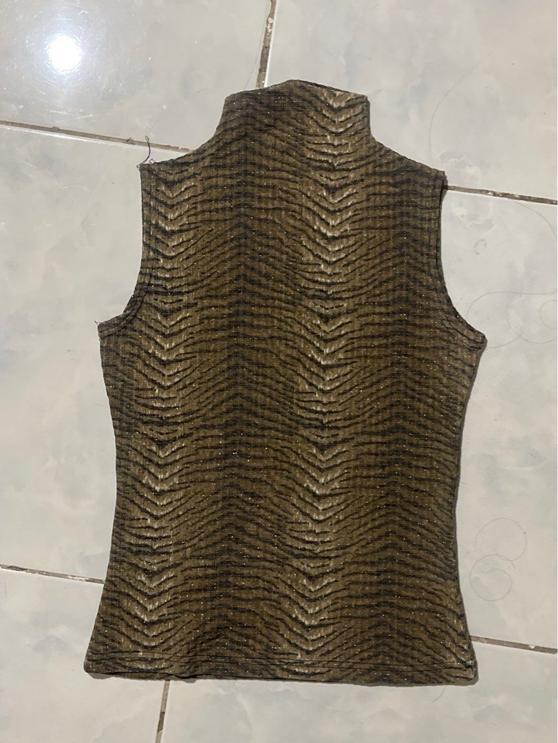 Y2K Gold Zebra Top (Category: Sleeveless) located in Liliw. Submitted by j444mes (Listing ID 1468458535, Image 1). Description: - Trendy dark olive green and black zebra print - Sparkly metallic gold threading woven throughout - Stretchy, textured ribbed fabric for a comfortable fit - Flattering scoop neckline and high cut legs - Sleeveless design, perfect for layering or night outs.