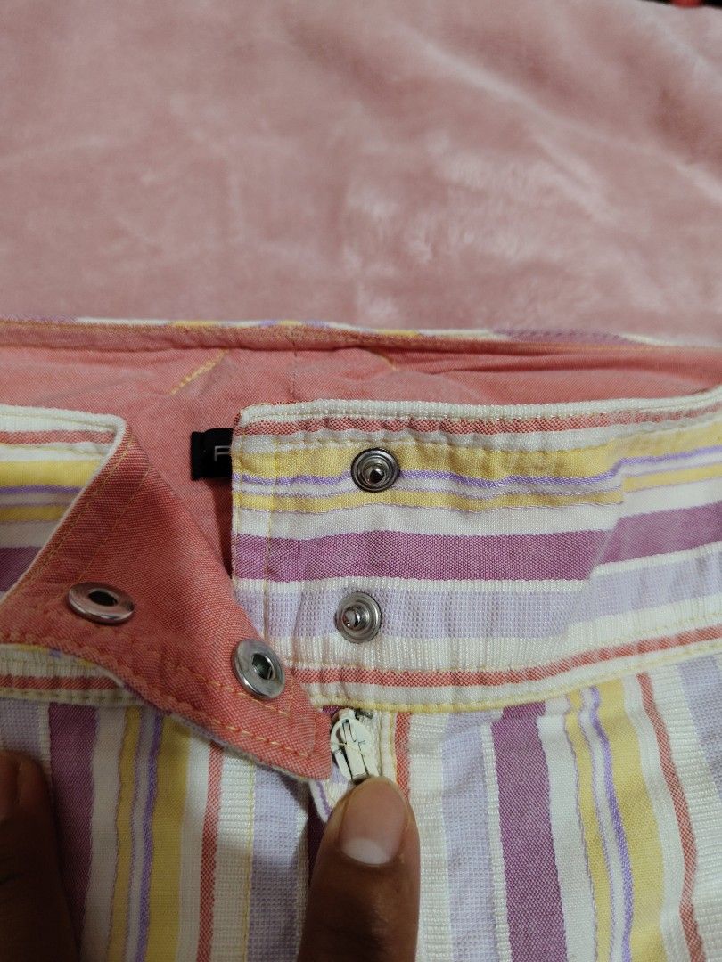 y2k Pennyblack Pink Striped Capri pants (Category: Jeans) located in Villasis. Submitted by trip_thrift15 (Listing ID 1468394402, Image 3). Description: - Brand: Pennyblack (Designed in Italy) - Size: 10 - Pattern: Vibrant colorful stripes in purple, yellow, and white - Fit: Mid-rise with a straight leg cut - Closure: Dual button closure and zipper fly - Details: Chic peach-toned inner waistband lining - Condition: Excellent pre-loved condition f
