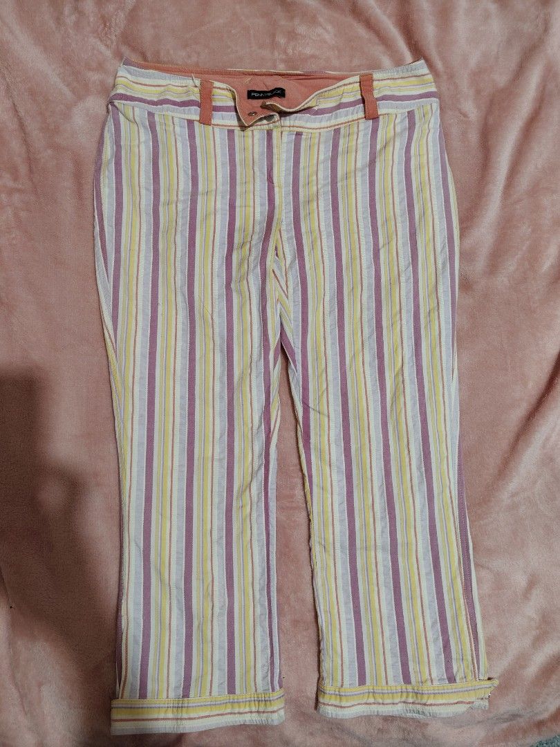 y2k Pennyblack Pink Striped Capri pants (Category: Jeans) located in Villasis. Submitted by trip_thrift15 (Listing ID 1468394402, Image 1). Description: - Brand: Pennyblack (Designed in Italy) - Size: 10 - Pattern: Vibrant colorful stripes in purple, yellow, and white - Fit: Mid-rise with a straight leg cut - Closure: Dual button closure and zipper fly - Details: Chic peach-toned inner waistband lining - Condition: Excellent pre-loved condition f