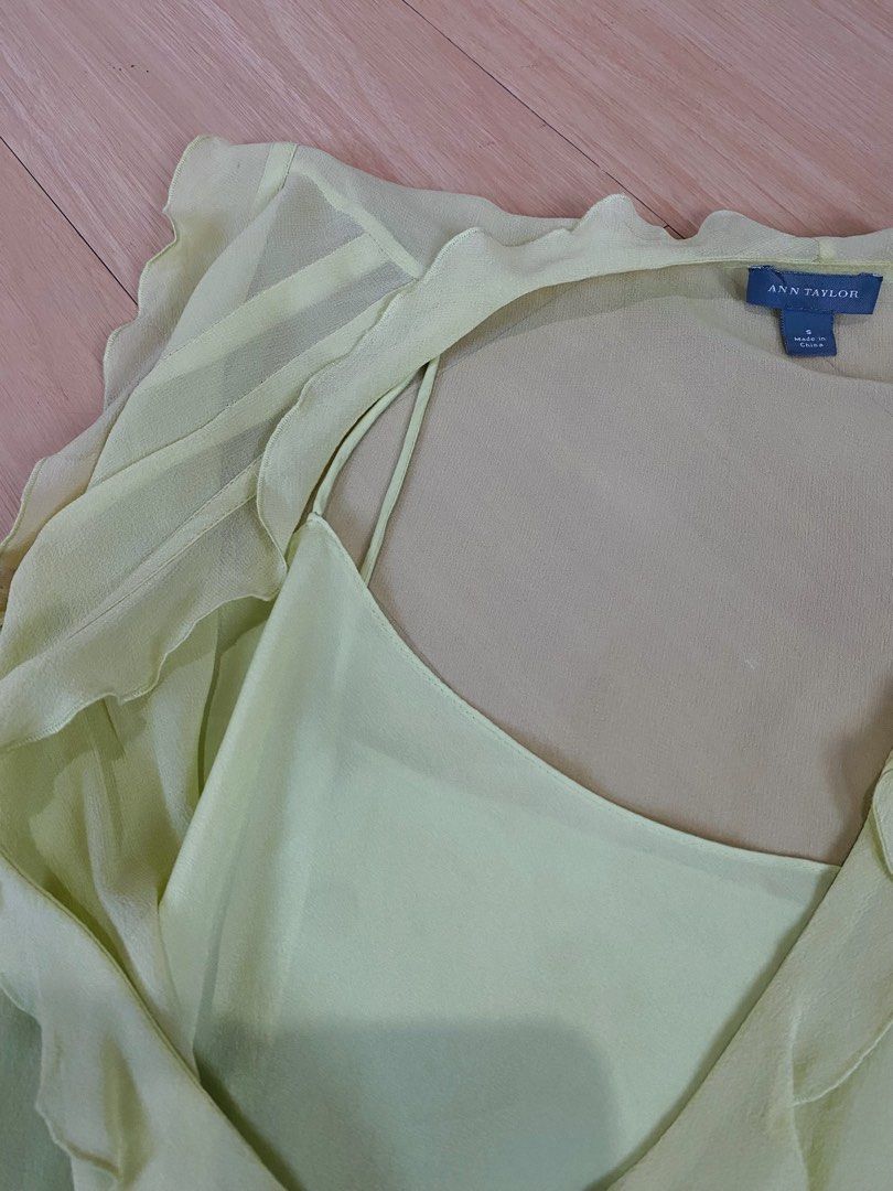 Y2k Silk Ruffle Sleeveless Blouse (Category: Blouses) located in Vigan. Submitted by yourcloset1001 (Listing ID 1468468055, Image 3). Description: - Brand: Ann Taylor - Size: Small - Color: Pale Yellow - Material: 100% Silk shell with polyester lining - Design: V-neck with ruffle trim along neckline and shoulders - Style: Peplum waist with built-in spaghetti strap camisole layer - Origin: Made in China - Condition: Excellent.