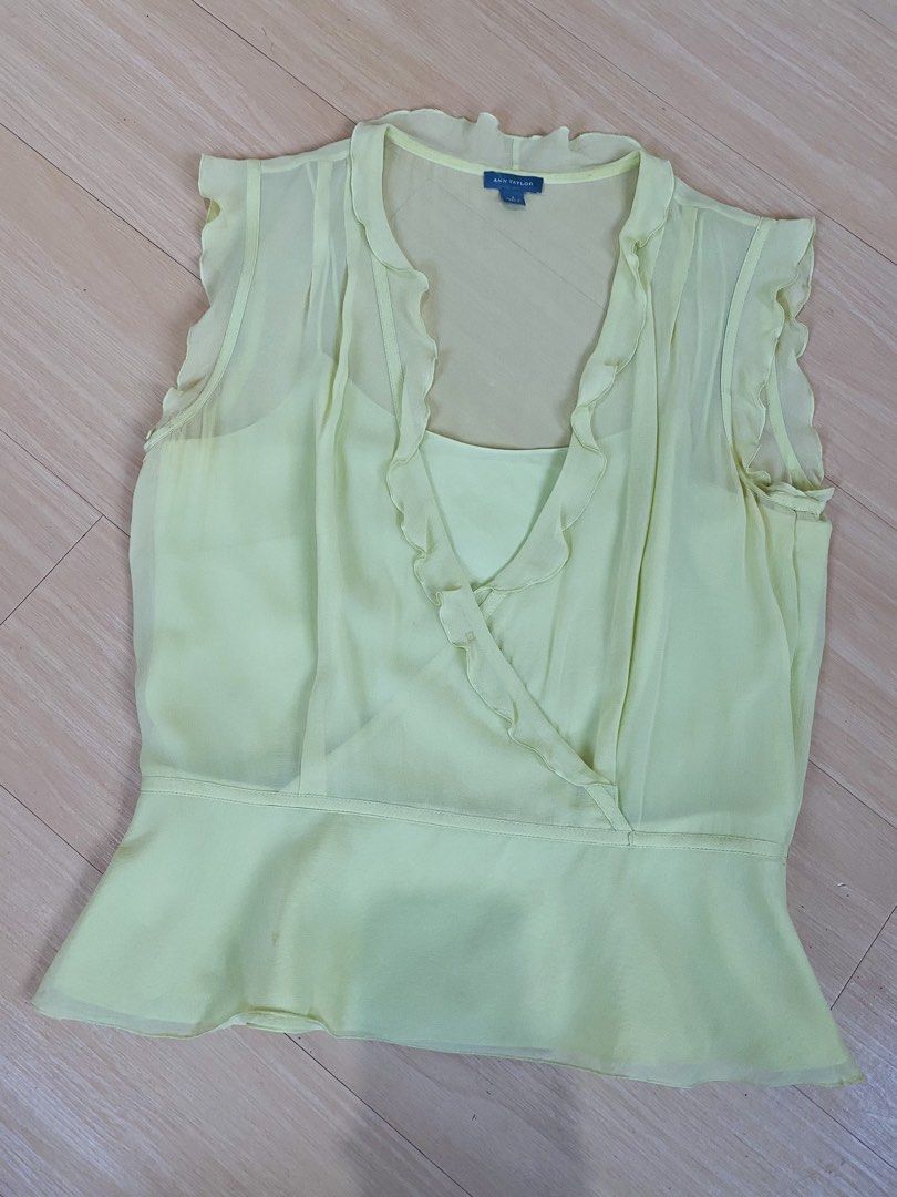 Y2k Silk Ruffle Sleeveless Blouse (Category: Blouses) located in Vigan. Submitted by yourcloset1001 (Listing ID 1468468055, Image 1). Description: - Brand: Ann Taylor - Size: Small - Color: Pale Yellow - Material: 100% Silk shell with polyester lining - Design: V-neck with ruffle trim along neckline and shoulders - Style: Peplum waist with built-in spaghetti strap camisole layer - Origin: Made in China - Condition: Excellent.
