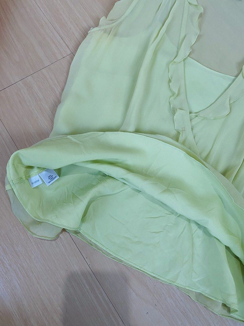 Y2k Silk Ruffle Sleeveless Blouse (Category: Blouses) located in Vigan. Submitted by yourcloset1001 (Listing ID 1468468055, Image 2). Description: - Brand: Ann Taylor - Size: Small - Color: Pale Yellow - Material: 100% Silk shell with polyester lining - Design: V-neck with ruffle trim along neckline and shoulders - Style: Peplum waist with built-in spaghetti strap camisole layer - Origin: Made in China - Condition: Excellent.