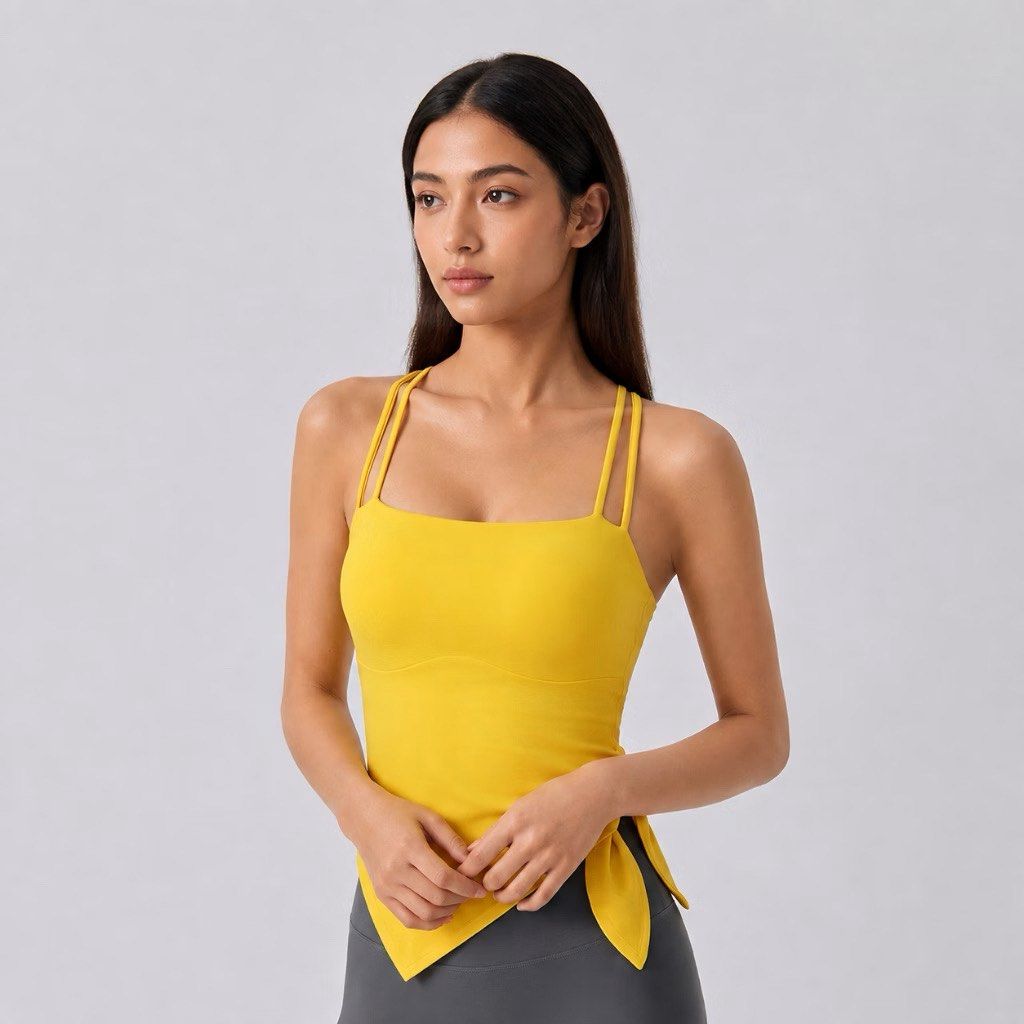 Yellow athletic tank top with double straps (Category: Sleeveless) located in Manila. Submitted by potchayy (Listing ID 1468478307, Image 1). Description: - Color: Bright yellow - Design: Square neckline with thin double straps - Detail: Unique asymmetric hem with a side tie - Material: Smooth and stretchy fabric - Best for: Workouts, yoga, or daily casual wear - Condition: Brand new / Excellent.