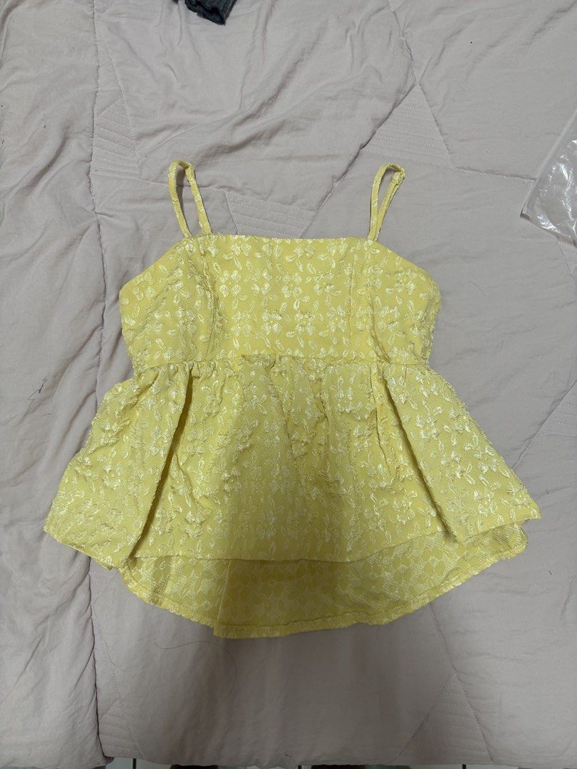 Yellow Floral Texture Spaghetti Strap Peplum Top (Category: Sleeveless) located in Manila. Submitted by unclutterwme (Listing ID 1468426093, Image 1). Description: - Color: Bright yellow with all-over floral print - Design: Square neckline, thin adjustable straps, and textured fabric - Fit: Flared peplum waist with a stylish high-low hemline - Style: Perfect for warm weather, beach trips, or easy layering.