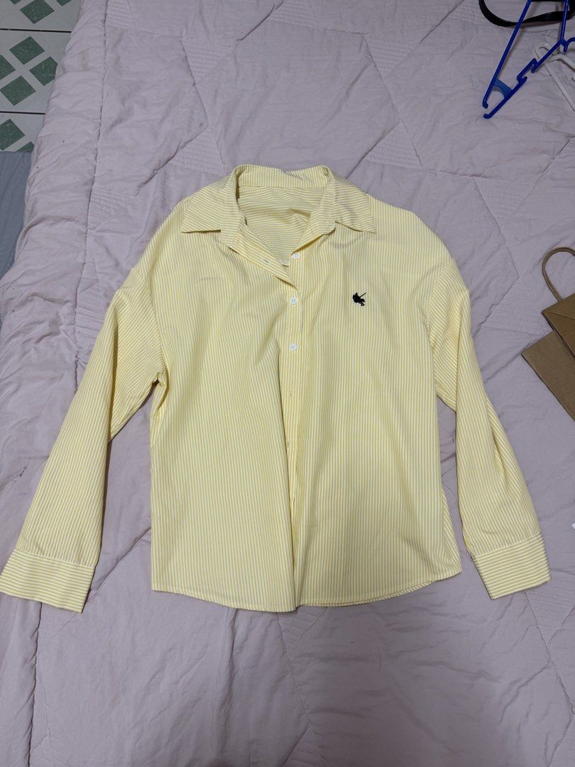 Yellow striped long sleeve button-up shirt (Category: Longsleeves) located in Manila. Submitted by unclutterwme (Listing ID 1468426588, Image 1). Description: Bestie! Clearing out my closet and selling this super cute yellow and white striped long sleeve button-up shirt from Shein. It has a nice crisp fabric, standard collar, white buttons, and a cute little black embroidered horse logo on the chest. Super versatile—you can wear it casually or st