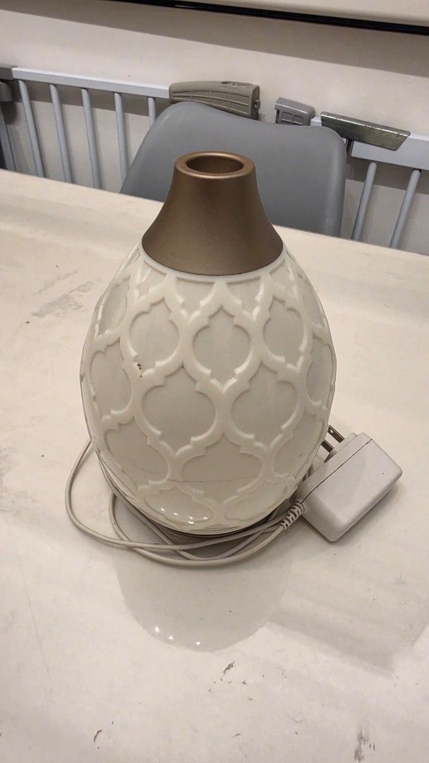 Young Living Desert Mist Diffuser (Category: Home Fragrance) located in Las Pinas. Submitted by sixtosengson (Listing ID 1468426539, Image 1). Description: - Ceramic essential oil diffuser with stylish geometric pattern - Cream and beige colorway with elegant gold-tone top nozzle - Functions as an aromatherapy diffuser and humidifier for small spaces - Includes internal water tank reservoir and original power adapter plug - Clean condition, fully