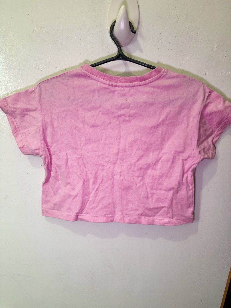 Zara Barbie Sequined Pink Crop Top (Category: Sleeveless) located in Manila. Submitted by potchayy (Listing ID 1468477891, Image 1). Description: - Brand: Zara - Style: Pink cropped t-shirt with short sleeves and round neckline - Design: Eye-catching large Barbie logo made of pink and white sequins - Material: Standard breathable cotton knit - Versatility: Perfect for casual wear, easily pairs with high-waisted jeans or shorts.