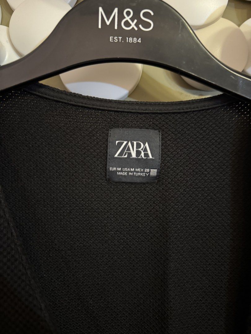 Zara Black Button-Up Vest Size M (Category: Sleeveless) located in Manila. Submitted by gabwie (Listing ID 1468409950, Image 2). Description: - Brand: Zara - Size: M (Standard fit) - Color: Black - Material: Textured knit fabric - Design: V-neckline with 4 black front buttons - Condition: minimal damage near buttons.