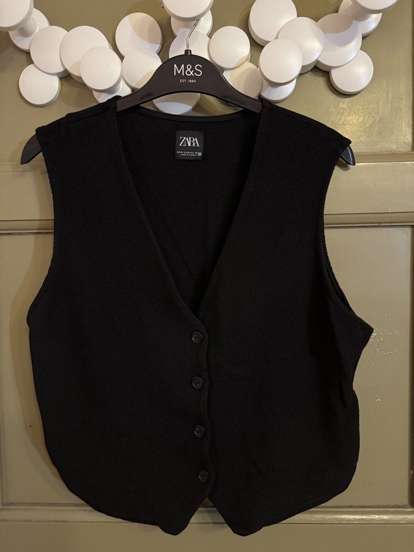 Zara Black Button-Up Vest Size M (Category: Sleeveless) located in Manila. Submitted by gabwie (Listing ID 1468409950, Image 1). Description: - Brand: Zara - Size: M (Standard fit) - Color: Black - Material: Textured knit fabric - Design: V-neckline with 4 black front buttons - Condition: minimal damage near buttons.
