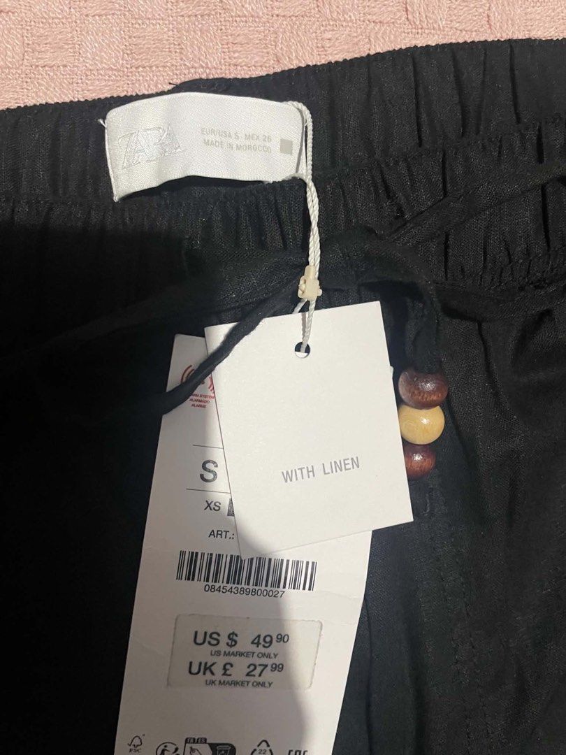 ZARA Black Linen Blend Drawstring Trousers Size S (Category: Trousers) located in Quezon City. Submitted by geohdz (Listing ID 1468310352, Image 2). Description: - Brand: ZARA - Item: Black linen blend trousers - Condition: Brand new with original tags attached - Size: S - Fit: Relaxed wide leg - Waist: Elastic waistband with wooden bead drawstring - Details: Front pockets - Origin: Made in Morocco - Fabric: Lightweight and ideal for warm weather