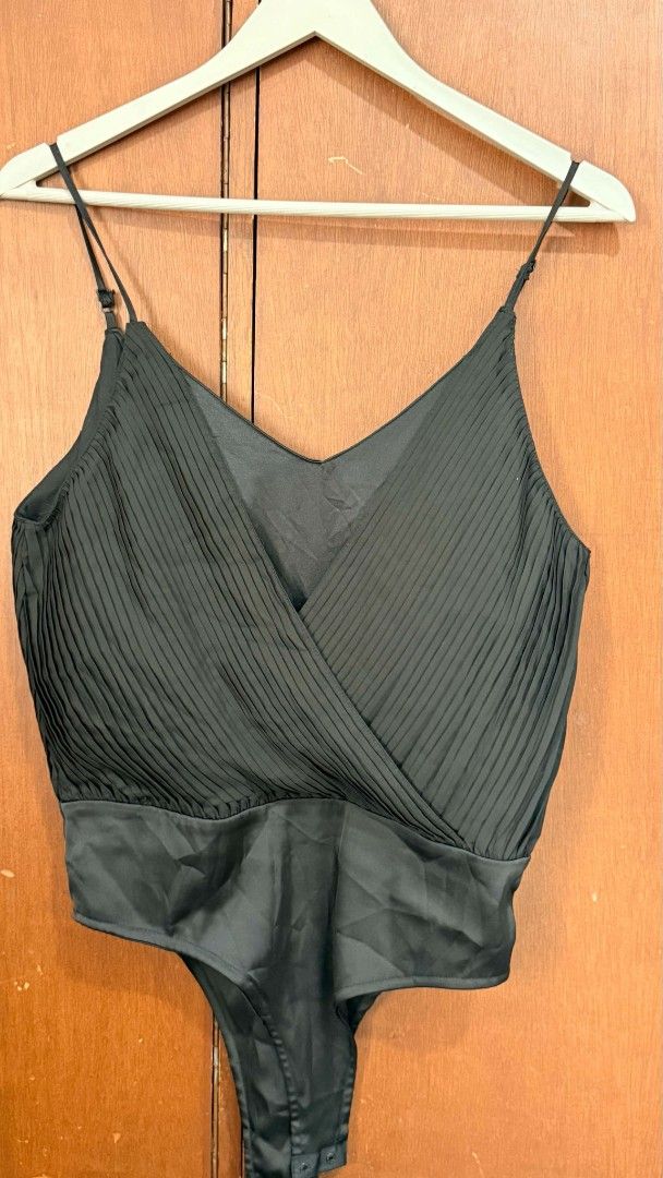 Zara Black Pleated Cami Bodysuit (Category: Sleeveless) located in Pasig City. Submitted by 35th.store (Listing ID 1468491565, Image 2). Description: - Brand: Zara - Style: Sleeveless bodysuit with crossover pleated front - Details: Adjustable thin straps, smooth satin bottom, convenient snap button closure - Size: Small (S) - Condition: Great / Like new - Versatility: Perfect for layering or a stylish night out look.