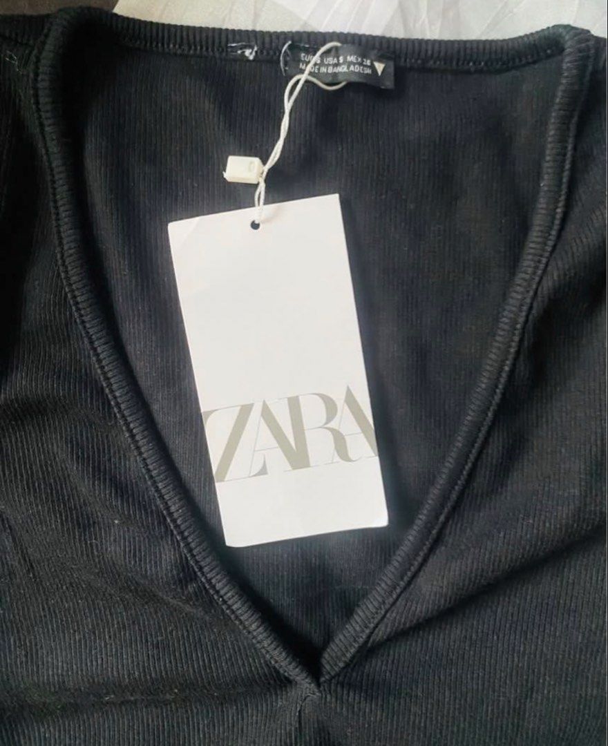 Zara Black Ribbed Wrap Crop Top Size S (Category: Sleeveless) located in Marikina City. Submitted by jessylady10 (Listing ID 1468382279, Image 2). Description: - Brand: Zara - Condition: Brand new with original tags - Size: S - Color: Black - Material: Stretchy ribbed fabric - Design: Short sleeves, deep V-neckline, and stylish wrap-around tie details at the waist - Origin: Made in Bangladesh - Style: Super versatile for everyday casual or dresse