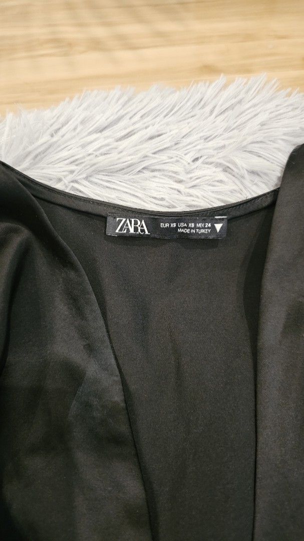 Zara Black Satin Knot Crop Top (Category: Blouses) located in Santa Rosa. Submitted by love.princess (Listing ID 1468335301, Image 3). Description: Brandnew, no more tags. S-M - Brand: Zara - Size: XS (Fit up to medium) - Material: Luxurious satin fabric - Origin: Made in Turkey - Design: Deep V-neckline with trendy front knot detail - Fit: Smocked elastic band at the back hem for extra comfort - Styling: Ideal for night outs or styling with high