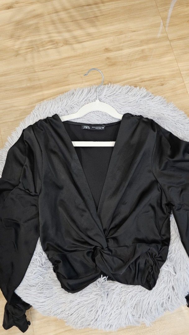 Zara Black Satin Knot Crop Top (Category: Blouses) located in Santa Rosa. Submitted by love.princess (Listing ID 1468335301, Image 2). Description: Brandnew, no more tags. S-M - Brand: Zara - Size: XS (Fit up to medium) - Material: Luxurious satin fabric - Origin: Made in Turkey - Design: Deep V-neckline with trendy front knot detail - Fit: Smocked elastic band at the back hem for extra comfort - Styling: Ideal for night outs or styling with high
