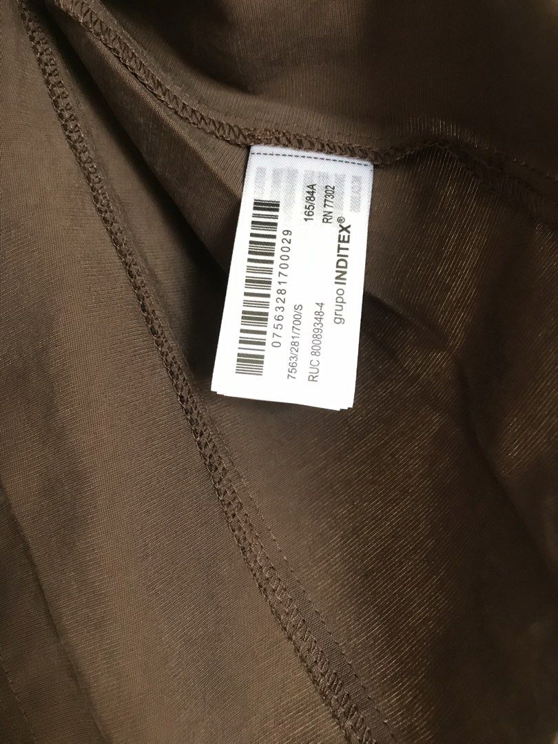 ZARA Dark Brown Blouse Size S (Category: Blouses) located in Cainta. Submitted by ukaymama (Listing ID 1468295786, Image 3). Description: - Brand: ZARA - Size: S - Color: Dark Brown - Material/Origin: Made in Turkey - Design: Short sleeves, round neckline, back zipper closure, and a unique front draped panel - Condition: Excellent, clean with no stains or damage.