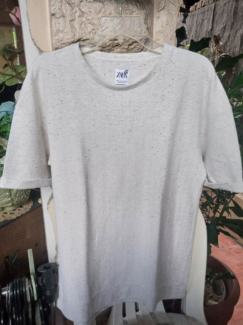 Zara shirt oversized textured knit tee (Category: Shirts) located in Pasig City. Submitted by rjkfindsofficial (Listing ID 1468352198, Image 1). Description: - Brand: ZARA - Color: Cream with black speckled details - Size: EUR M / USA M / MEX 40 - Material: 74% cotton blend (Made in Turkey) - Fit: Relaxed fit with crew neck and rolled sleeve cuffs - Condition: Wash tag clearly attached - ​Minimal signs of usage / smooth pre-loved condition (no ho