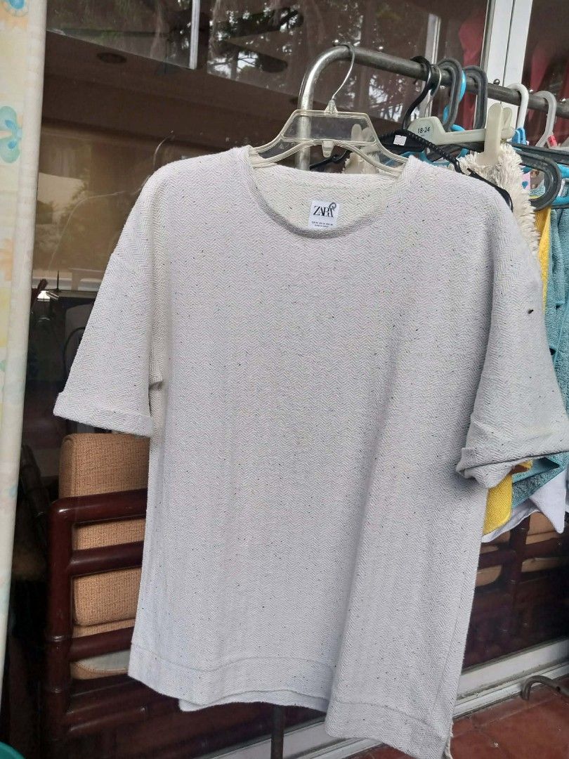 Zara shirt oversized textured knit tee (Category: Shirts) located in Pasig City. Submitted by rjkfindsofficial (Listing ID 1468352198, Image 2). Description: - Brand: ZARA - Color: Cream with black speckled details - Size: EUR M / USA M / MEX 40 - Material: 74% cotton blend (Made in Turkey) - Fit: Relaxed fit with crew neck and rolled sleeve cuffs - Condition: Wash tag clearly attached - ​Minimal signs of usage / smooth pre-loved condition (no ho
