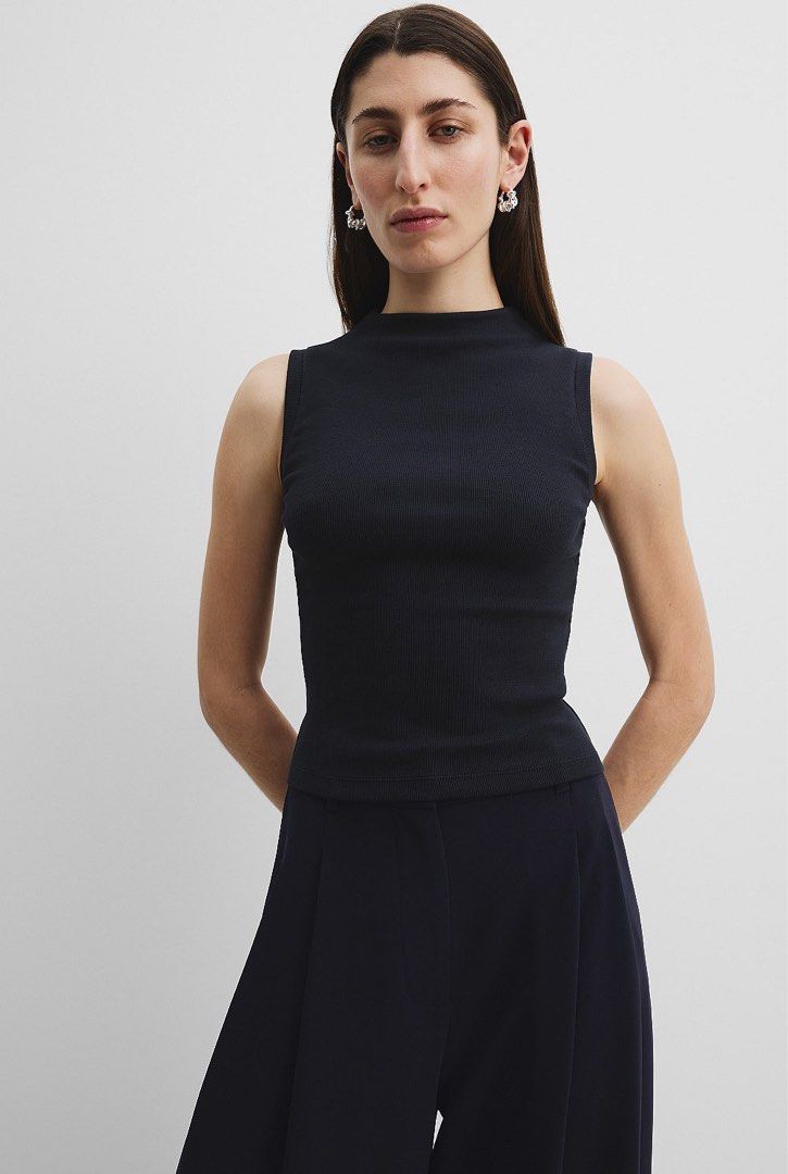 Zara Premium Collection (Category: Sleeveless) located in Manila. Submitted by gabwie (Listing ID 1468411136, Image 2). Description: - Brand: Zara Woman Mock Neck Top - Color: Navy blue - Material: Textured ribbed fabric - 2nd photo: For reference only since top if kinda flowy at the bottom - Zara Premium : Bought for 2,995 - Very stylish !! - Needs ironing.