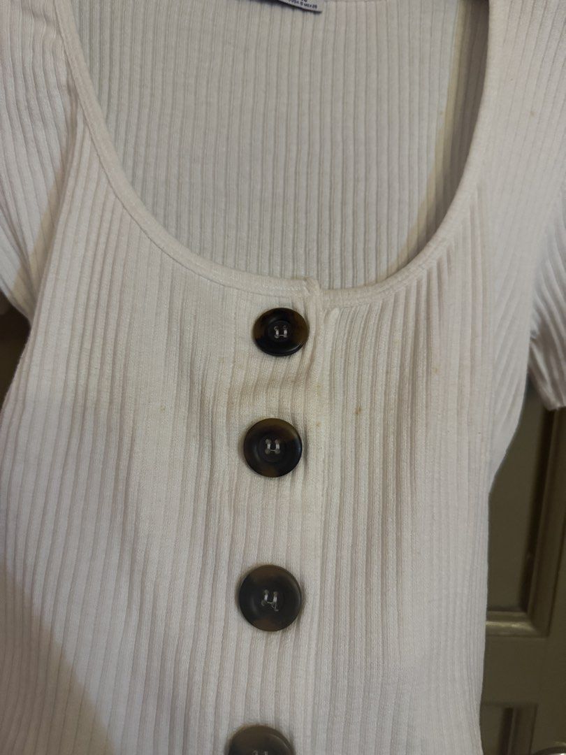 Zara Ribbed Button-Up White Top (Category: Blouses) located in Manila. Submitted by gabwie (Listing ID 1468406947, Image 2). Description: - Brand/Style: Zara Trafaluc white ribbed top - Size: S (EUR/USA S, MEX 26) - Details: Short sleeves, scoop neckline, dark tortoiseshell front buttons - Condition: Pre-loved with small yellowish stains near the button placket (please check pictures closely) - Yellowish stain can be removed with Zonrox — I can’t