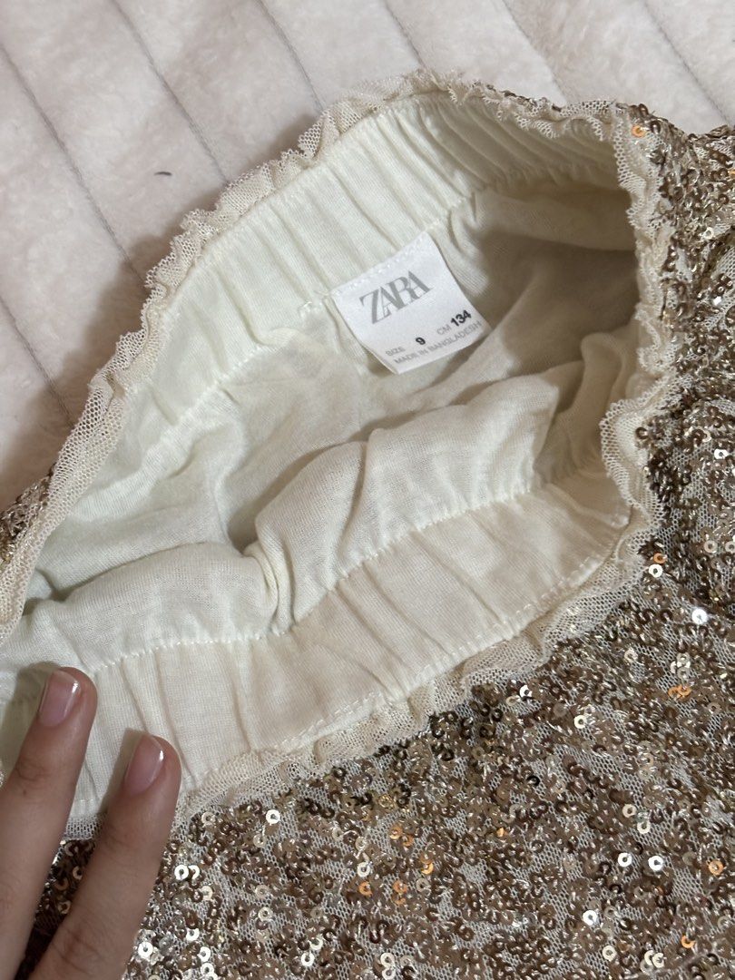 Zara Sequined Skirt Size 134 cm (Size 9) (Category: Skirts) located in Quezon City. Submitted by hadescloset (Listing ID 1468394449, Image 1). Description: - Size: 9 years (fits 134 cm height) - Design: Sparkly gold sequins with stylish tiered layers - Comfort: Easy slip-on elastic waistband with a soft, skin-friendly mesh lining - Origin: Made in Bangladesh - Perfect for: Holiday parties, birthdays, and special events.