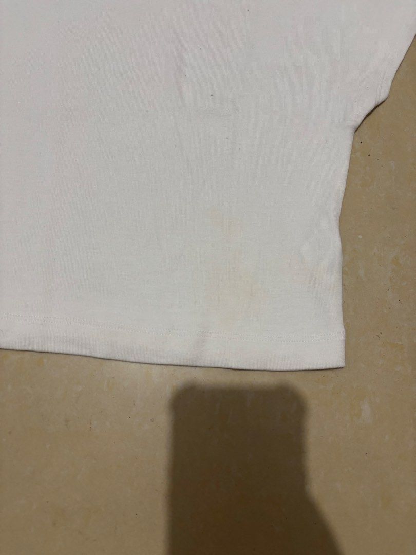 Zara White Crop Top Size S (Category: Shirts) located in Manila. Submitted by van390867 (Listing ID 1468410598, Image 2). Description: - Brand: Zara - Style: Casual short-sleeve crop top with scoop neckline - Color: Plain white - Size: S (tag on collar) - Condition: Good, with a faint yellowish stain near the bottom hem (visible in the second photo).