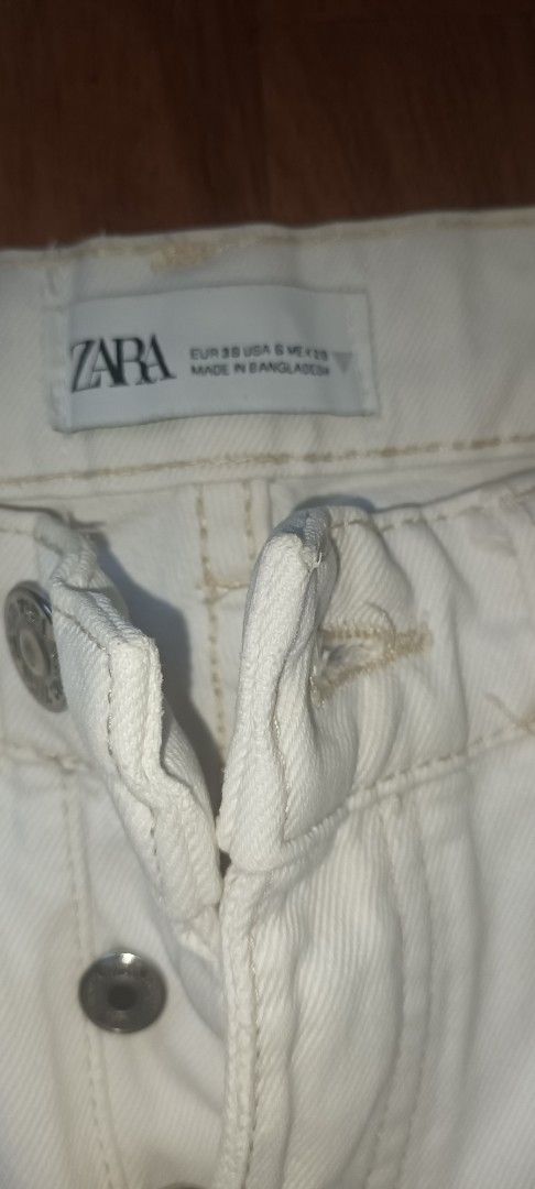 ZARA White Denim Jeans Raw Hem (Category: Jeans) located in San Fernando. Submitted by kathleenmanarang (Listing ID 1468306744, Image 3). Description: - Brand: Zara - Color: White - Size: EUR 38 / USA S / MEX 28 - Style: Straight leg with button fly and classic 5-pocket design. High-waisted - Feature: Trendy raw frayed hem at the ankles - Measurements: Waist approx. 38 cm across, Total length approx. 98 cm - Material: Made in Bangladesh - Conditi