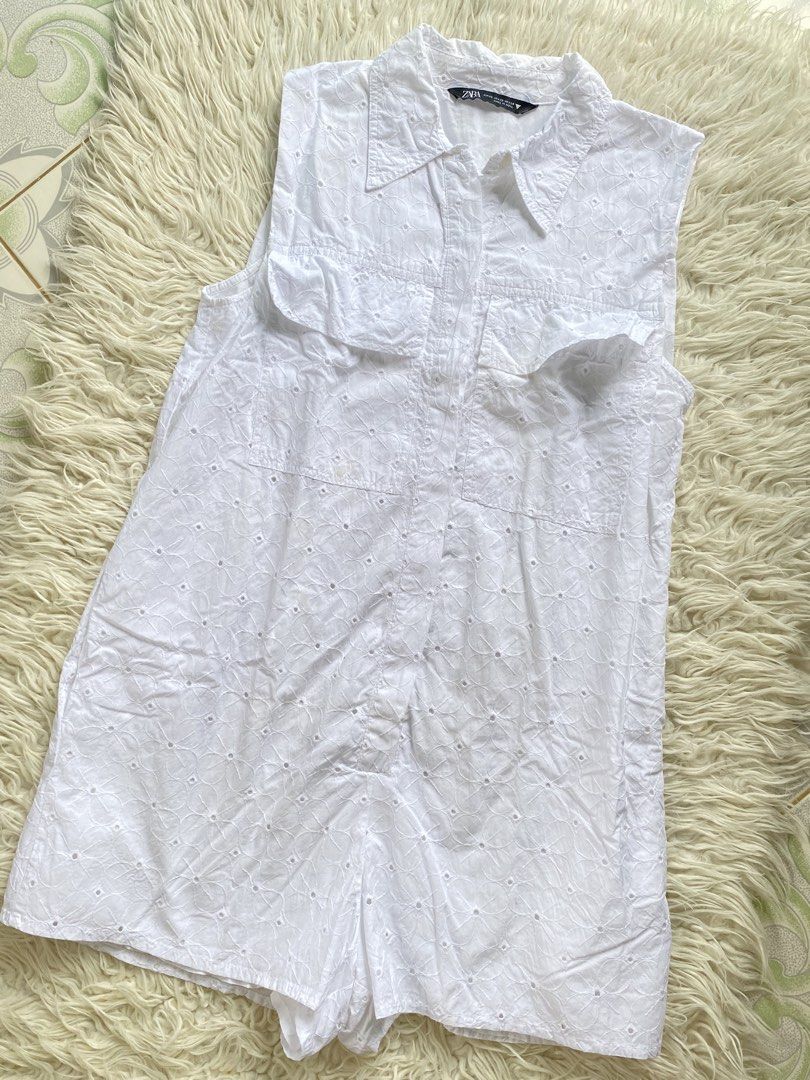 ZARA White Eyelet Sleeveless Romper (Category: Rompers) located in Tabaco. Submitted by camila_dp (Listing ID 1468286091, Image 1). Description: - Brand: Zara - Style: Sleeveless button-down romper with collar - Detail: All-over floral eyelet embroidery and dual chest pockets - Fabric: Lightweight and breathable - Size: XS but can fit Xs to Small.