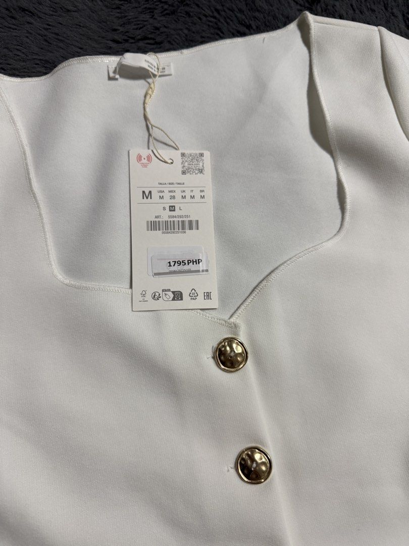 Zara White Peplum Top (Category: Blouses) located in Las Pinas. Submitted by juls_mp (Listing ID 1468445623, Image 2). Description: - Brand: Zara - Style: Peplum top with structured hem - Size: M - Color: White - Details: Square neckline, short sleeves, 4 gold metal buttons - Condition: Brand new, never worn - Tag: Original retail tag attached (1,795 PHP).