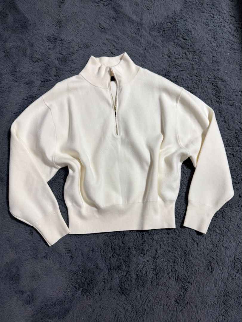 Zara White Zip-Up Knit Sweater (Category: Coats, Jackets and Outerwear) located in Las Pinas. Submitted by juls_mp (Listing ID 1468439873, Image 1). Description: - Brand: Zara - Size: L - Color: White (Neutral) - Style: Half-zip neckline with dropped shoulders for a relaxed fit - Details: Ribbed collar, cuffs, and hem - Material: Soft knit fabric - Condition: No tag but never been used.