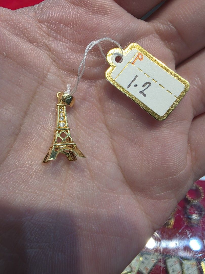 18k Eiffel Tower Gold Pendant 750 (Category: Necklaces) located in Manila. Submitted by trumpisthedevil (Listing ID 1468607659, Image 2). Description: - Material: Gold (Stamped 750 on bail) - Design: Detailed openwork Eiffel Tower with small stone accents - Weight: 1.2 grams (tag attached) - Condition: Clean and ready to wear - Note: Pendant only, chain not included.