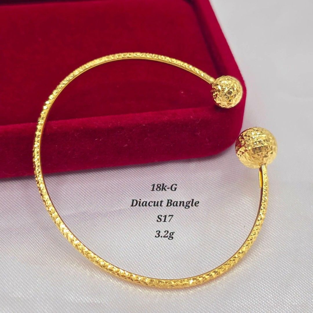 18k Gold Diacut Bangle S17 3.2g (Category: Bracelets) located in Marikina City. Submitted by emmstaule (Listing ID 1468583032, Image 1). Description: - Material: 18k Gold - Weight: 3.2 grams - Size: S17 - Design: Diacut sparkly finish with textured sphere ends - Fit: Open design for easy slip-on wear - Style: Versatile piece, great for everyday wear or stacking.