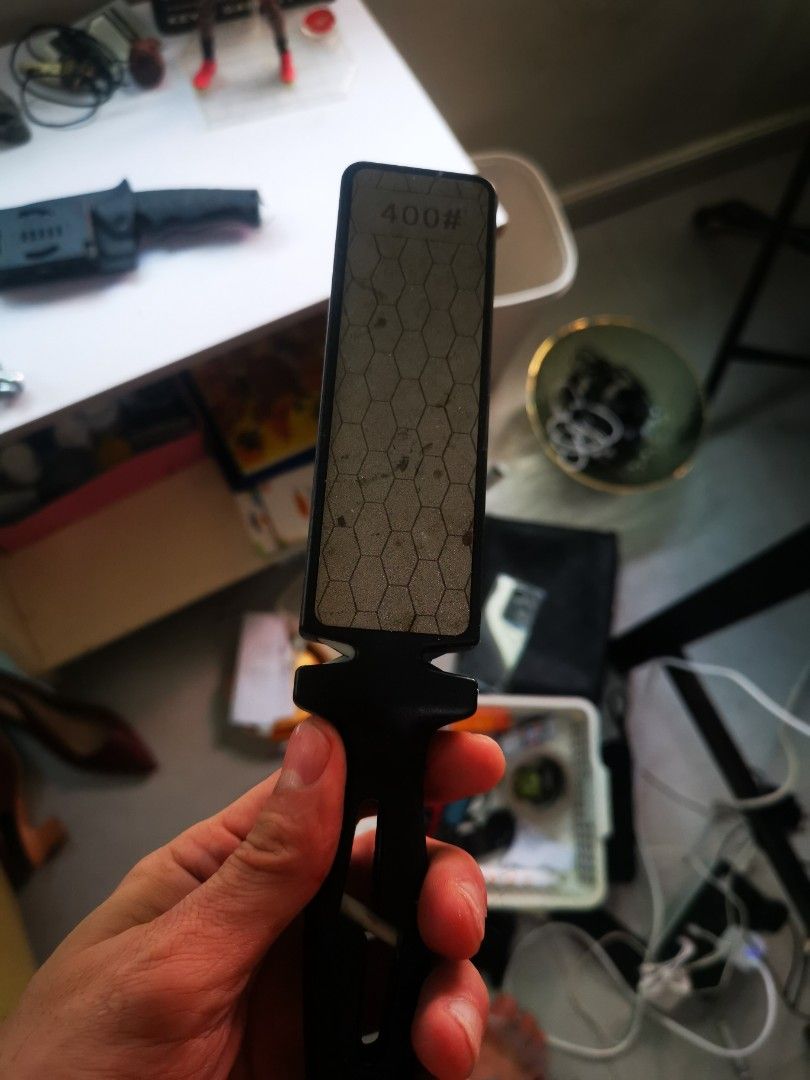 400# Grit Diamond Knife Sharpener Pocket Sharpening Tool (Category: Knives & Chopping Boards) located in Pasay City. Submitted by wizemindz138970 (Listing ID 1468590579, Image 1). Description: - Type: Handheld knife sharpener with 400 grit diamond surface - Design: Hexagonal pattern on the plate for efficient sharpening, features an ergonomic black plastic handle with a convenient lanyard hole - Versatility: Perfect for kitchen knives, pocket kni