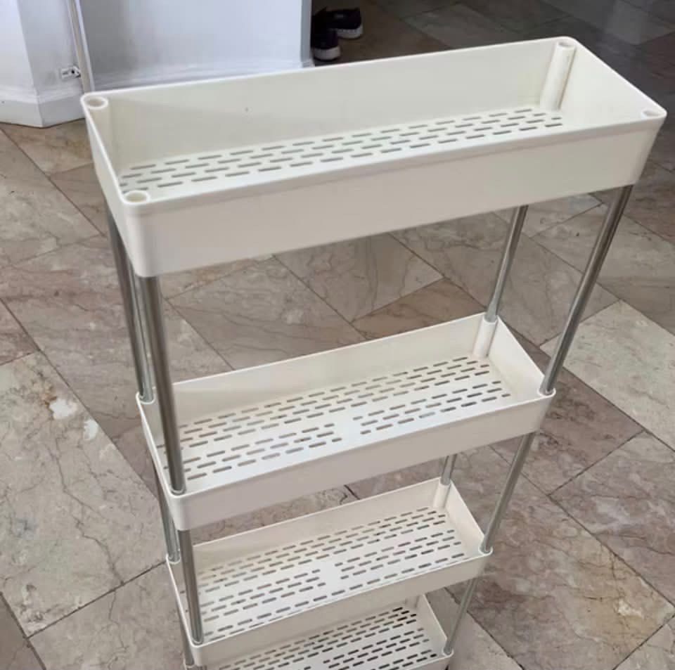 4-Tier Slim Storage Rack Organizer White (Category: Shelves, Cabinets & Racks) located in Pasig City. Submitted by karinauhh (Listing ID 1468670688, Image 1). Description: BRAND NEW. 3 pcs availavle - Space-saving slim design fits tight gaps between appliances, pantries, or sinks - 4 spacious utility baskets with vented slots for airflow and drainage - Sturdy metal poles support a lightweight, portable structure - Smooth-rolling wheels make it ea