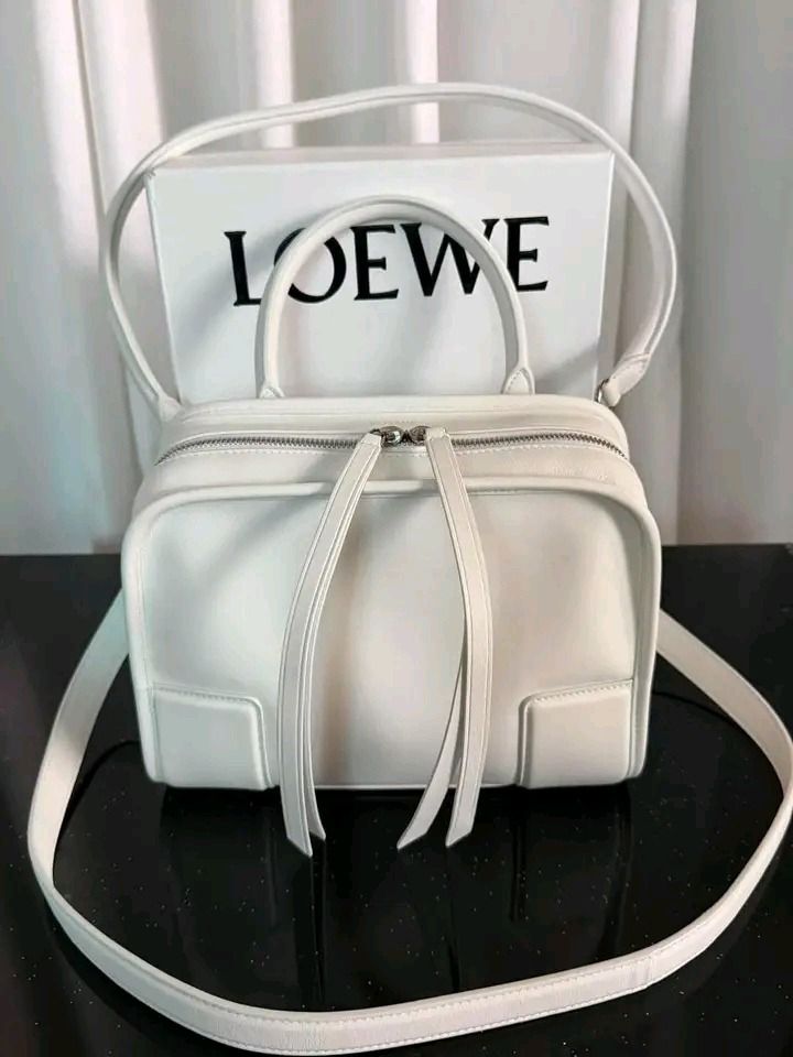 💜 Loewe Amazona 180 Small leather top-handle bag (Category: Luxury Bags & Wallets) located in Lala. Submitted by mohsin0825 (Listing ID 1468577366, Image 2). Description: Loewe Amazona 180 Small leather top-handle bag 22,990p plus sf Like new/ Brandnew Genuine Leather Lining: fabric, leather Made in Spain Color: white Designer color name: White Top handle, Detachable, adjustable shoulder strap Closure: two-way zipped top Loewe continues to shape
