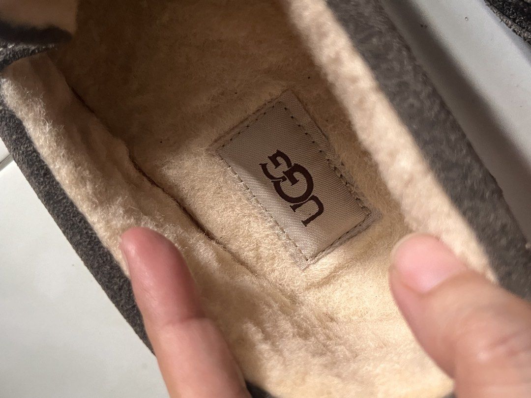 🇺🇸 UGG Brown Suede Slippers Loafers (Category: Slippers & Slides) located in Manila. Submitted by prelovedpick.com (Listing ID 1468566459, Image 3). Description: - Brand: UGG - Material: Brown suede upper with soft plush shearling lining - Style: Slip-on loafer design - Sole: Textured rubber outsole for good grip - Condition: Interior tag intact, normal wear on soles - Features: Extremely warm and comfortable for indoor/outdoor lounging.