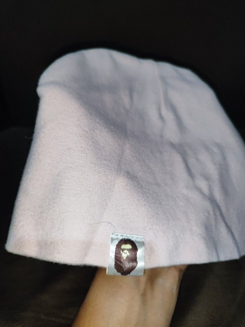 A Bathing Ape BAPE Pink Beanie with Logo Tag (Category: Caps & Hats) located in Paniqui. Submitted by arlenepari29210 (Listing ID 1468687038, Image 2). Description: - Brand: A Bathing Ape (BAPE) - Color: Light Pink - Material: Soft, comfortable cotton - Design: Classic pull-on knit beanie with signature ape head logo tag near the hem - Style: Versatile streetwear accessory, can be worn slouchy or fitted - Condition: Excellent / Great for colder d