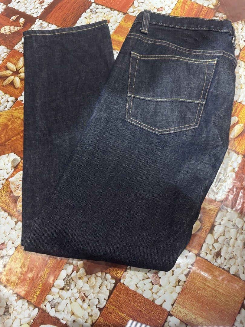 AAPE By A Bathing Ape Original 100% AAPE (Category: Luxury Apparel) located in Manila. Submitted by wildbear.e10374 (Listing ID 1468587003, Image 2). Description: - Brand: AAPE By A Bathing Ape - Item: Dark Denim Jeans - Size: W36 L31 - Fit: Regular fit with straight legs - Design: Big 'AAPE Now Union' graphic printed on the front leg - Details: Red back leather patch, red embroidered logo on the right back pocket, and branded AAPE buttons - Cond