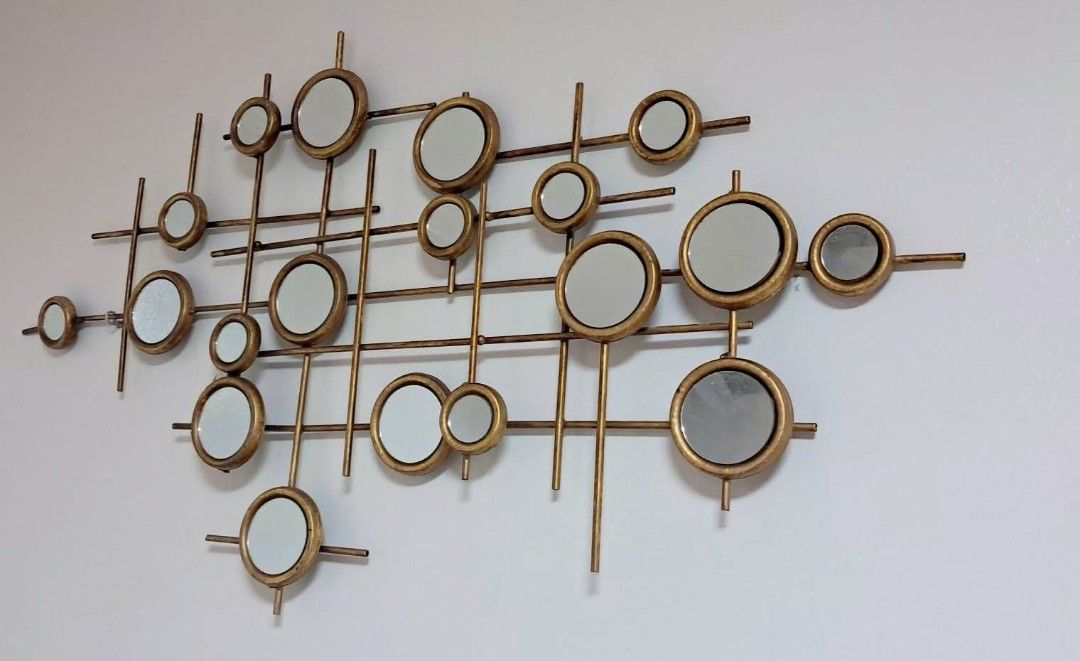 Abstract Gold Geometric Wall Mirror Art Piece (Category: Mirrors) located in Las Pinas. Submitted by mamshie_tin (Listing ID 1468545571, Image 1). Description: - Style: Mid-century modern gold metal wall art - Design: Multiple circular mirrors arranged in a stylish grid framework - Condition: Excellent, clean frame with zero cracks on the glass - Placement: Ideal statement piece for living rooms, hallways, or entryways - Convenience: Comes with a