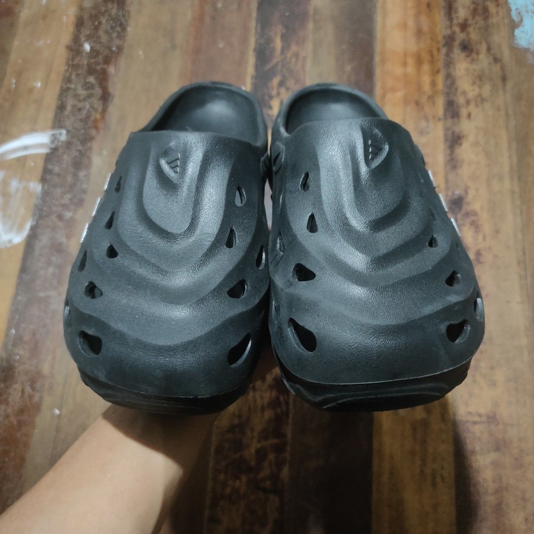 Adidas Adilette Clog Black Slides (Category: Slippers & Slides) located in Taguig. Submitted by actualizeboutique (Listing ID 1468521930, Image 2). Description: - Brand: Adidas - Style: Slip-on clog with ventilation holes - Color: Black with silver three-stripe branding - Features: Textured footbed and grooved rubber outsoles for better grip - Condition: Minor wear on soles from previous use - Ideal for: Casual everyday use, beach, or quick erran