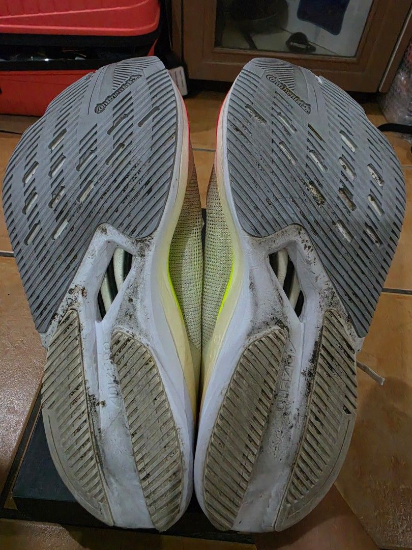 Adidas Adizero Boston 12 W (Category: Sneakers) located in Paranaque City. Submitted by krisfuentes (Listing ID 1468674417, Image 3). Description: - Brand/Model: Adidas Adizero Boston 12 W - Size: US 7.5 / UK 6 / EUR 39 1/3 / JP 245 / CHN 240 - Colorway: White upper with black stripes, red lining, and neon accents - Sole/Cushioning: Lightstrike Pro midsole foam with Continental rubber outsole - Condition: Pre-loved with visible dirt on the outsol