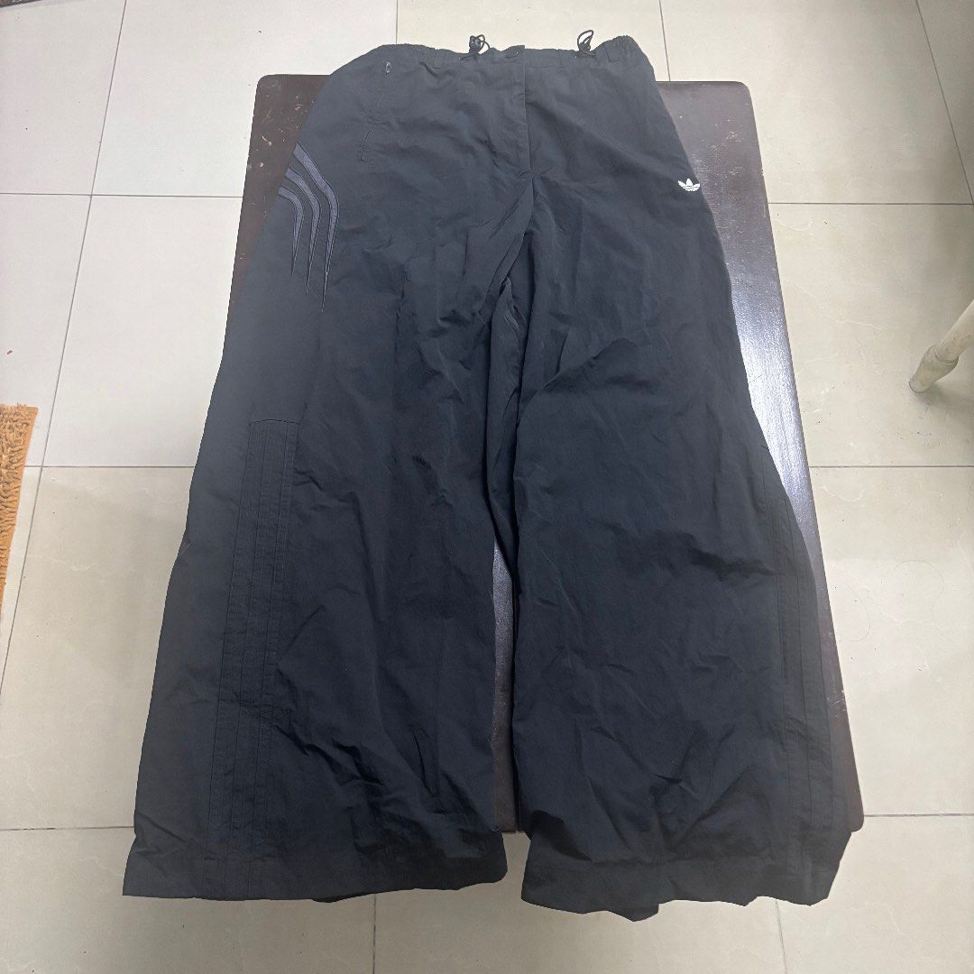 Adidas Black Track Pants Size M (Category: Joggers) located in Manila. Submitted by waywaya (Listing ID 1468596244, Image 1). Description: - Brand: Adidas - Color: Classic black with white trefoil logo and three stripes - Size: Tag M (Waist: 14 in across, Length: 39.5 in) - Features: Elastic waistband with adjustable drawcords, convenient zippered side pockets - Material: Lightweight and breathable for easy movement Meetups are possible in Ubelt 