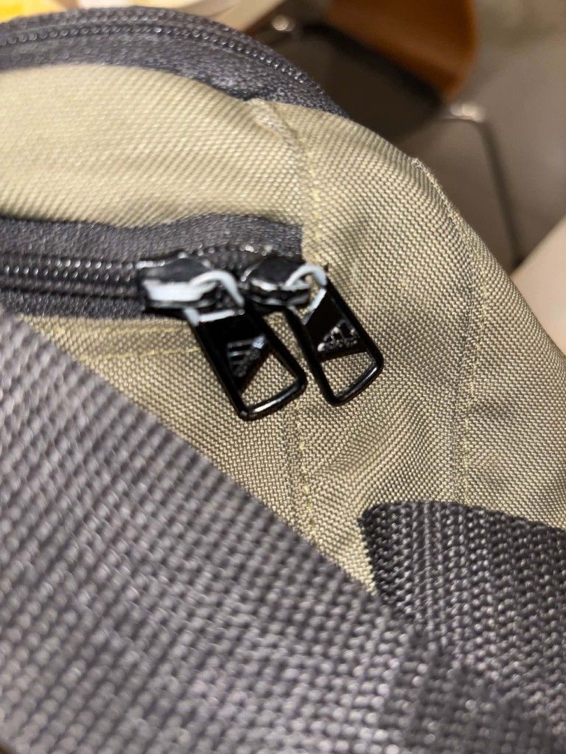 Adidas Linear Duffel S Olive Green Gym Bag (Category: Sling Bags) located in Manila. Submitted by yongyongse72148 (Listing ID 1468654872, Image 2). Description: - Brand: Adidas - Color: Olive green with bold white logo and black contrast bottom - Size: NS (One Size) - Origin: Made in Indonesia - Features: Sturdy black carry handles, intact inside tag with QR code and product details - Best for: Gym workouts, sports activities, and short weekend t