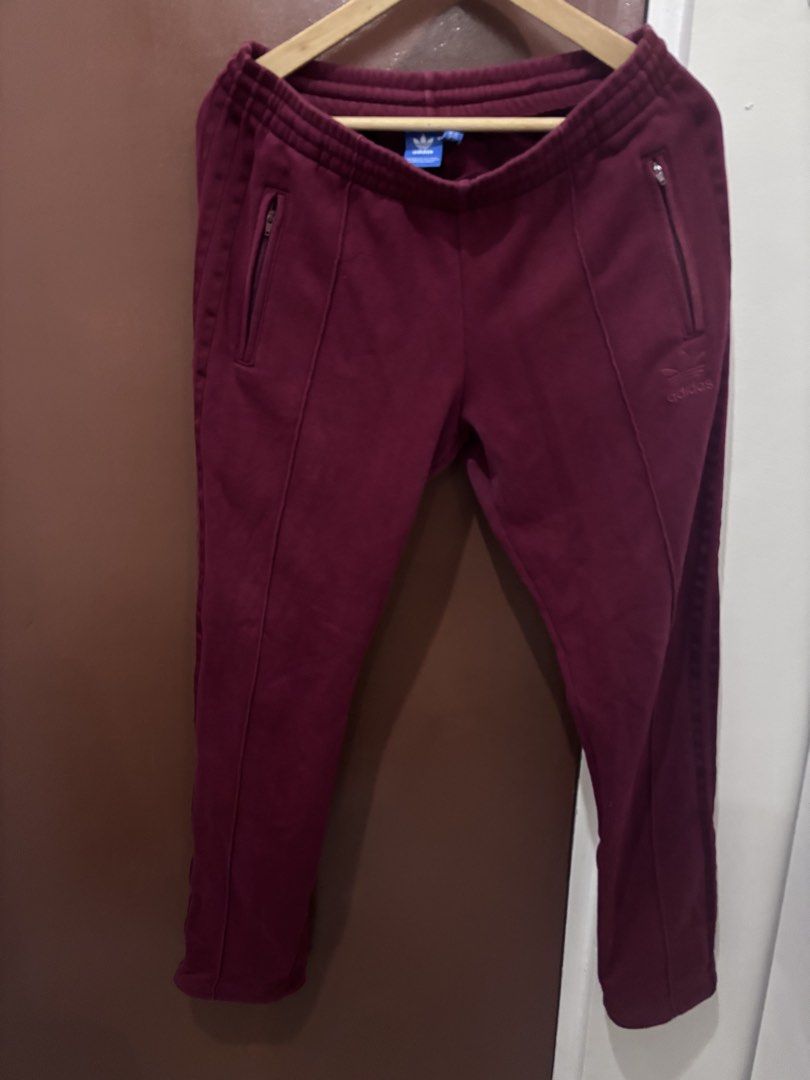 Adidas Maroon Track Pants Size (Category: Joggers) located in Quezon City. Submitted by juiriya (Listing ID 1468653093, Image 1). Description: - Color: Rich Maroon - Material: Soft and cozy velour fabric - Size: UK 8, US S, D 34, F 36, E 34, I 40 (fits Small) - Waistband: Elastic with adjustable drawstring - Pockets: Convenient zippered pockets on both sides - Details: Embroidered Adidas trefoil logo on the left leg & ribbed ankle cuffs .