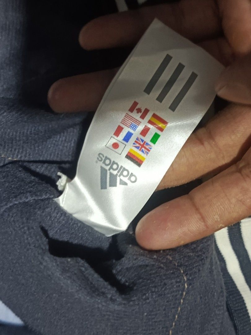 Adidas Navy Thin Padded Track Jacket Size 105 (Category: Coats, Jackets and Outerwear) located in City of Isabela. Submitted by warmbird.d06e6f (Listing ID 1468617072, Image 3). Description: - Brand: Adidas - Color: Navy blue with white logo - Size: 105 (Made in Korea) - Style: Full zip, thin padded, ribbed striped cuffs and hem - Features: Two front zippered pockets - Condition: Comfortable layering piece, perfect for cooler weather.