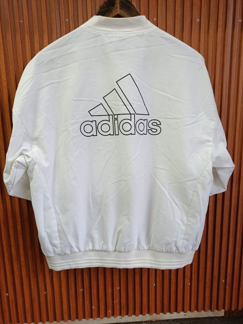 Adidas White Bomber Jacket Size A/L (Category: Coats, Jackets and Outerwear) located in Bayombong. Submitted by rheaaa00530 (Listing ID 1468625458, Image 2). Description: - Authentic white Adidas bomber jacket - Full zip closure with ribbed collar and cuffs - Large iconic Adidas logo printed on the back - Breathable mesh lining inside and practical side welt pockets - Tag size: A/L 170/92A (Manufactured: 06/20) - Clean, versatile style ideal for 