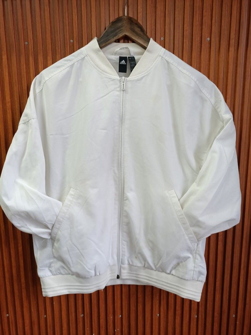 Adidas White Bomber Jacket Size A/L (Category: Coats, Jackets and Outerwear) located in Bayombong. Submitted by rheaaa00530 (Listing ID 1468625458, Image 1). Description: - Authentic white Adidas bomber jacket - Full zip closure with ribbed collar and cuffs - Large iconic Adidas logo printed on the back - Breathable mesh lining inside and practical side welt pockets - Tag size: A/L 170/92A (Manufactured: 06/20) - Clean, versatile style ideal for 