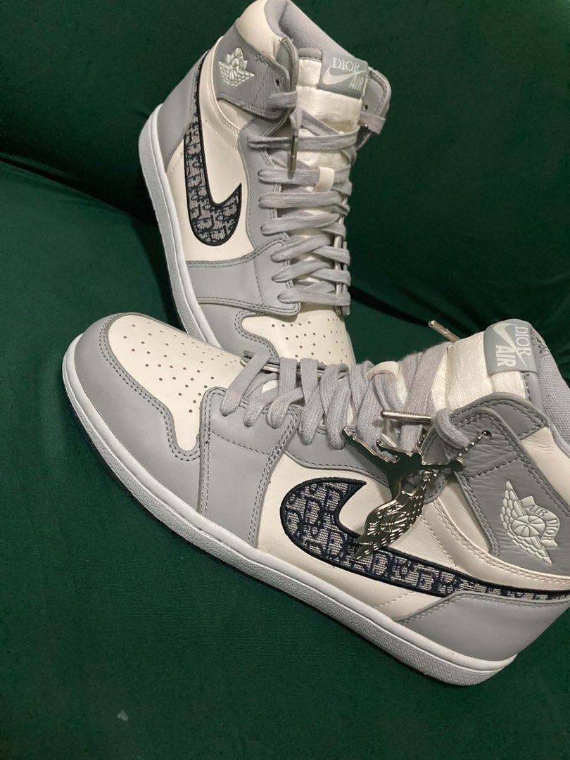 AIR JORDAN x DIOR (Category: Sneakers & Footwear) located in Dapitan. Submitted by thrift_archive2026 (Listing ID 1468649665, Image 1). Description: AIR JORDAN x DIOR 👟 Colorway:White / Gray Style:High-top basketball sneakers (OFF/LEGIT ONLY) Design:Monogram-patterned Swoosh, Air Dior-style Wings logo, lace-up closure, ankle strap, and decorative metal charms Look:Premium streetwear aesthetic — perfect for casual outfits and sneaker collections 