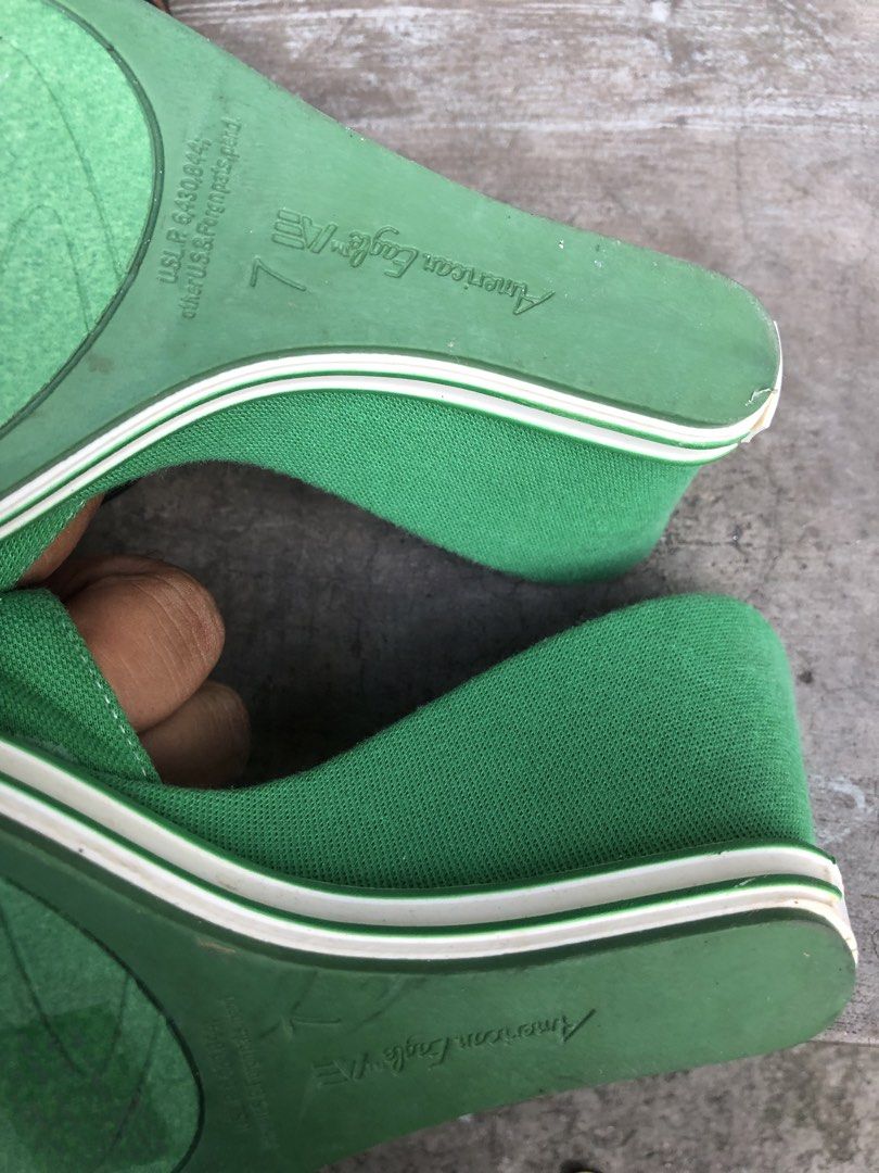 American Eagle Green Striped Wedge Sandals Size 7 (Category: Wedges) located in Manila. Submitted by tunicy2k (Listing ID 1468584457, Image 3). Description: - Brand: American Eagle - Style: Open-toe slip-on wedge sandals - Color/Pattern: Green and off-white stripes with green front strap and buckle accent - Size: 7 M - Condition: Brand new with tag still attached - Details: Wedge heel for a nice lift, logo printed on footbed and embossed on rubbe