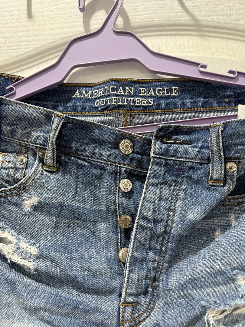 American Eagle Outfitters Distressed Denim Shorts (Category: Shorts) located in Manila. Submitted by prelov3dbysteph (Listing ID 1468550794, Image 2). Description: - Brand: American Eagle - Style: High-waisted denim shorts with button fly - Wash: Medium blue with heavy distressing - Details: Frayed raw hems and contrasting darker denim back patch pocket - Pockets: Classic five-pocket styling - Condition: Excellent, ready to wear.