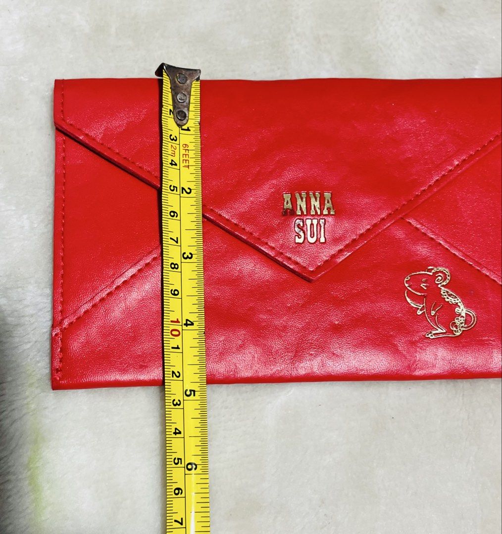 Anna Sui Red Envelope Clutch (Category: Clutches) located in Mandaue City. Submitted by chuchi152615 (Listing ID 1468573551, Image 3). Description: - Brand: Anna Sui - Color: Bright red with gold-tone hardware - Material: Faux leather - Design: Envelope clutch featuring a cute embroidered mouse graphic on the front - Closure: Secure magnetic snap - Dimensions: Approx. 20 cm x 11.5 cm - Interior: Clean with a small branded fabric tag - Condition: 